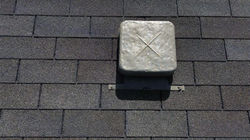 Box vent seated on an asphalt shingle slope