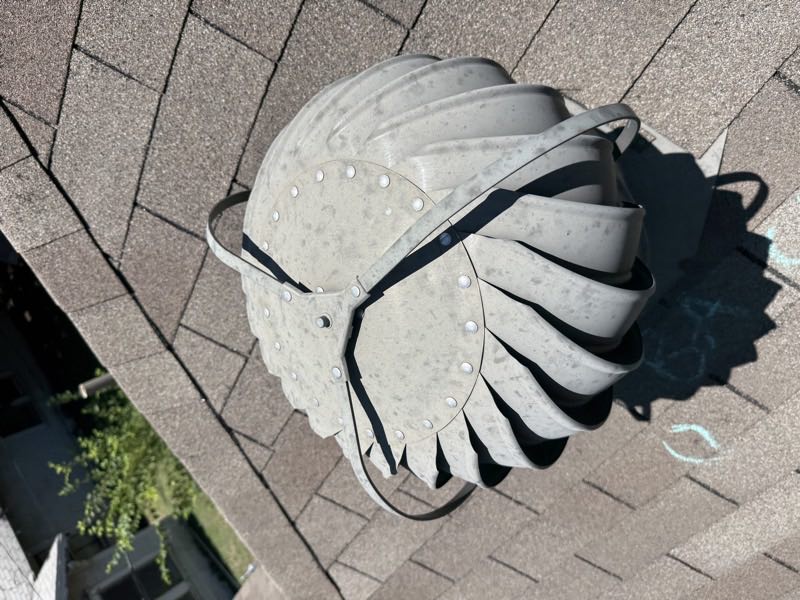Turbine vent removed from the roof, weathered and dented