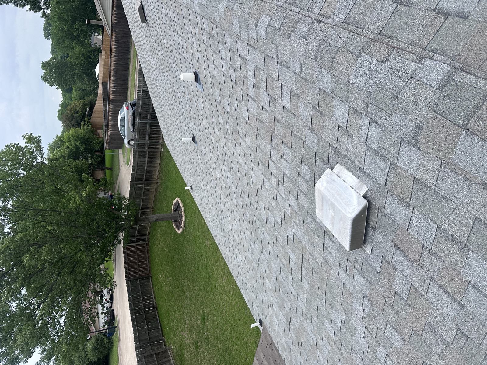 Roof vents across a shingle field from above